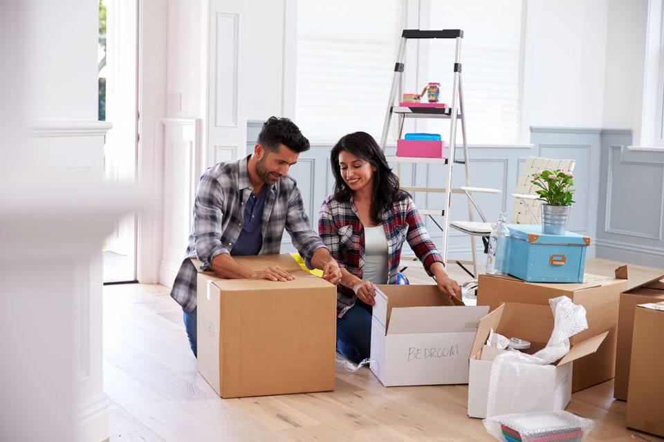 young couple unpacking in their new home