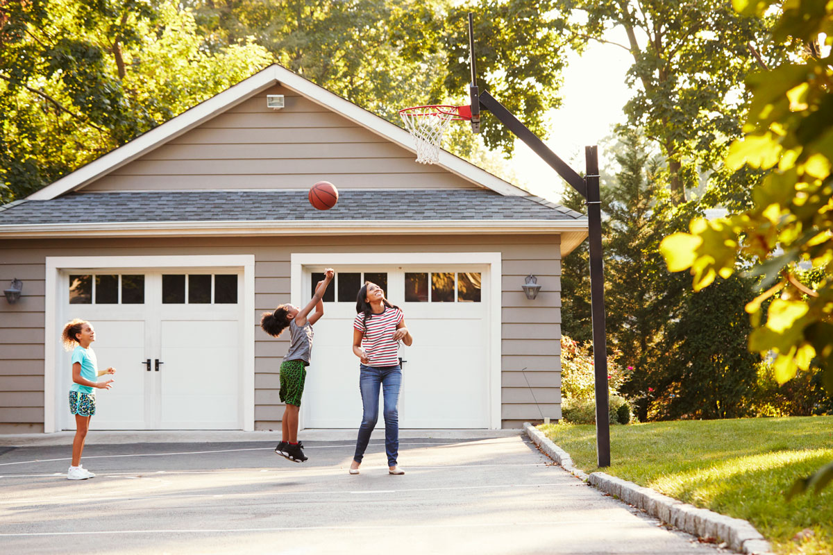 playing basketball at the golden hour in the driveway